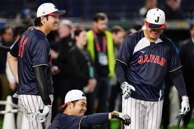 Japan's Shohei Ohtani (L), Munetaka Murakami (R) and Kensuke Kondoh (bottom) warm up prior to the start of the World Baseball Classic (WBC) Pool C game between Japan and Australia at the Tokyo Dome in Tokyo on March 8, 2026. (Photo by Yuichi YAMAZAKI / AFP)