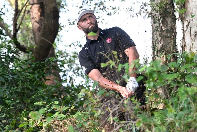 LIV Golf team Legion XIII GC captain Jon Rahm of Spain hits a ball out of the rough on the 18th fairway on day four of the LIV Golf tournament at Fanling golf club in Hong Kong on March 8, 2026. (Photo by Peter PARKS / AFP)