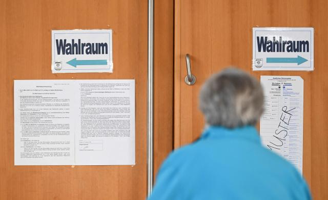 A woman leaves a polling station in Gutach, southwestern Germany, on March 8, 2026, after she cast her vote for the state election in the German federal state of Baden-Wuerttemberg. Voters head to the polls on March 8 in the southwestern state of Baden-Wuerttemberg, a prosperous hub of Germany's flagship auto sector with a population of 11.2 million. (Photo by THOMAS KIENZLE / AFP)