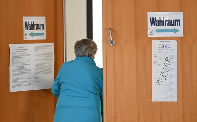 A woman leaves a polling station in Gutach, southwestern Germany, on March 8, 2026, after she cast her vote for the state election in the German federal state of Baden-Wuerttemberg. Voters head to the polls on March 8 in the southwestern state of Baden-Wuerttemberg, a prosperous hub of Germany's flagship auto sector with a population of 11.2 million. (Photo by THOMAS KIENZLE / AFP)