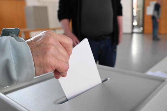 A voter casts her ballot at a polling station in Gutach, southwestern Germany, on March 8, 2026, during the state election in the German federal state of Baden-Wuerttemberg. Voters head to the polls on March 8 in the southwestern state of Baden-Wuerttemberg, a prosperous hub of Germany's flagship auto sector with a population of 11.2 million. (Photo by THOMAS KIENZLE / AFP)