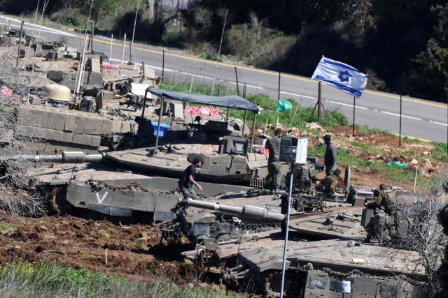 Israeli tanks gather at a position along the Israel-Lebanon border on March 8, 2026. Lebanon was drawn into the Middle East war on March 2, when Iran-backed militant group Hezbollah attacked Israel in response to the killing of Iranian supreme leader Ayatollah Ali Khamenei during US-Israeli strikes. Israel, which has kept up strikes targeting Hezbollah despite a 2024 ceasefire, launched multiple waves of strikes this week across Lebanon and sent ground troops into border areas. (Photo by Jack GUEZ / AFP)