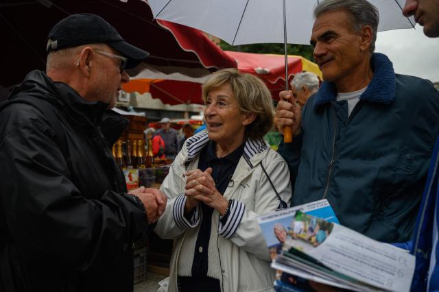 (FILES) Mayor of Montauban Brigitte Bareges speaks to shoppers at a market in Montauban on June 22, 2024. Although Brigitte Barèges is not appearing on the ballot for the municipal elections in Montauban for the first time since 2001. The former mayor, formerly of the LR and now of the UDR, left her post in 2024 to return to parliament in the early general elections. However, she was declared ineligible a year later by the Constitutional Council due to irregularities in her campaign accounts. The woman who long reigned over public life in Montauban, was on France 3 on March 4, 2026 with five of the seven candidates who came to debate before the first round, to support the man she has chosen as her heir: her former director general of services, Didier Lallemand. (Photo by Ed JONES / AFP)
