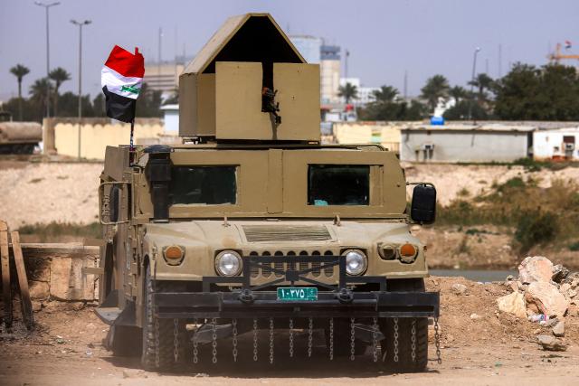 An Iraqi army armoured humvee vehicle is deployed near the banks of the Tigris River to protect the US embassy headquarters in Baghdad's fortified "Green Zone" on March 8, 2026. Air defence systems intercepted rockets fired at the US embassy in Baghdad late on March 7, security sources told AFP. It is the first such attack on the embassy in Baghdad since the start of the war in the Middle East, triggered by a joint US-Israeli attack on Iran, into which Iraq has been dragged. (Photo by AHMAD AL-RUBAYE / AFP)