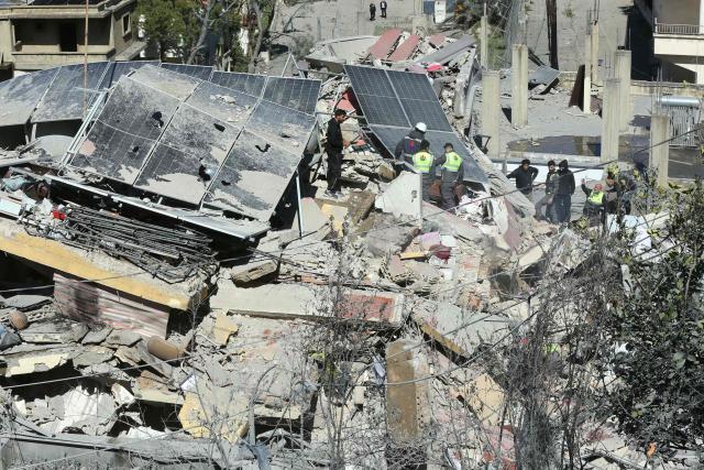 First aid responders inspect the site of an Israeli airstrike that targeted a neighborhood in the southern Lebanese village of Ghaziyeh on March 8, 2026. Lebanon was drawn into the Middle East war on March 2, when Iran-backed militant group Hezbollah attacked Israel in response to the killing of Iranian supreme leader Ayatollah Ali Khamenei during US-Israeli strikes. Israel, which has kept up strikes targeting Hezbollah despite a 2024 ceasefire, launched multiple waves of strikes this week across Lebanon and sent ground troops into border areas. (Photo by MAHMOUD ZAYYAT / AFP)