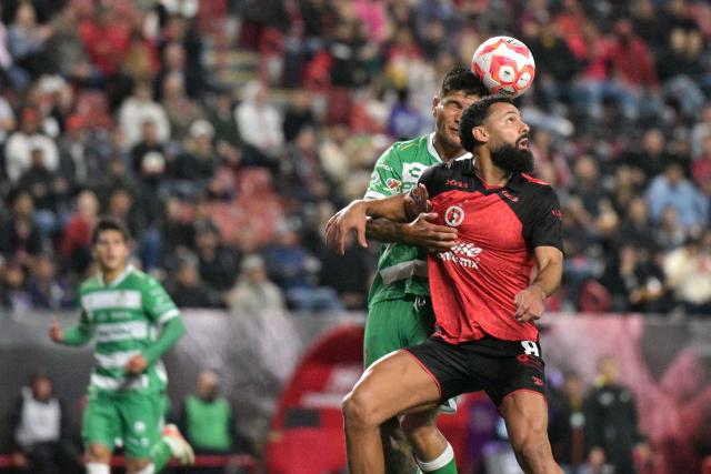 Tijuana's Spanish forward #09 Mourad El Ghezouani (R) and Santos' Argentine defender #02 Bruno Amione (L) fight for the ball during the Liga MX Clausura football match between Tijuana and Santos Laguna at Caliente stadium in Tijuana, Mexico on March 8, 2026. (Photo by Guillermo Arias / AFP)