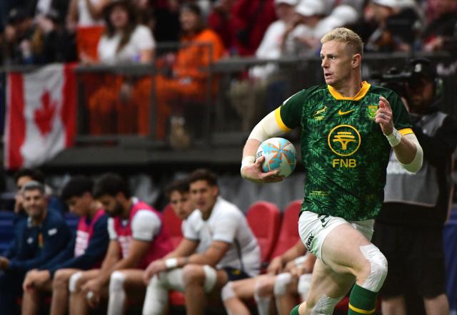 South Africa’s Ryan Oosthuizen scores a try against Spain in the final game of the HSBC SVNS Vancouver rugby sevens tournament at BC Place in Vancouver, Canada, on March 8, 2026. (Photo by Don MacKinnon / AFP)
