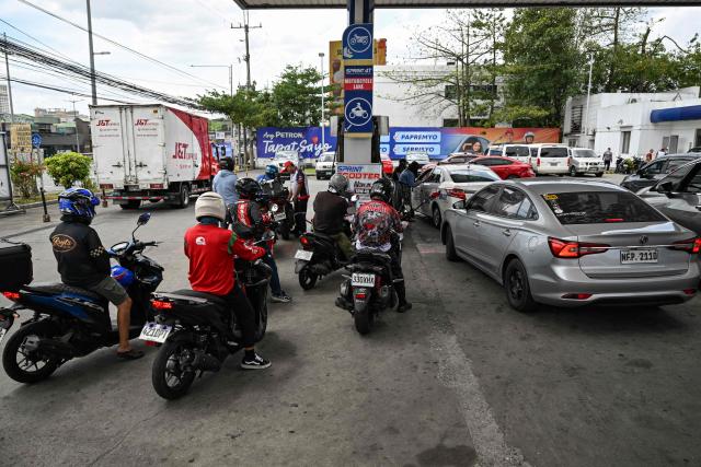 Motorists queue at a gas station amid rising petrol prices in Quezon City, Metro Manila on March 9, 2026. The price of the main US benchmark for oil surged more than 30 percent on March 9, 2026 over concerns that the Middle East war could create prolonged supply disruptions. (Photo by Jam STA ROSA / AFP)