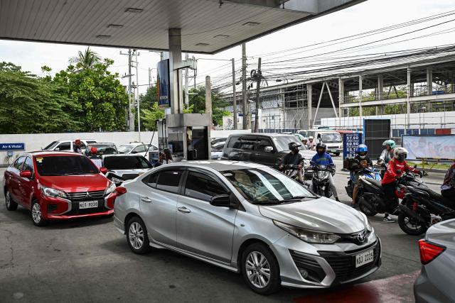 Motorists queue at a gas station amid rising petrol prices in Quezon City, Metro Manila on March 9, 2026. The price of the main US benchmark for oil surged more than 30 percent on March 9, 2026 over concerns that the Middle East war could create prolonged supply disruptions. (Photo by Jam STA ROSA / AFP)