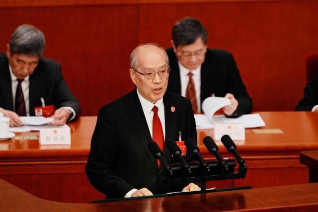 Zhang Jun, China’s President of the Supreme People's Court, speaks during a plenary session of China's National People's Congress in Beijing on March 9, 2026. (Photo by Vincent Thian / POOL / AFP)