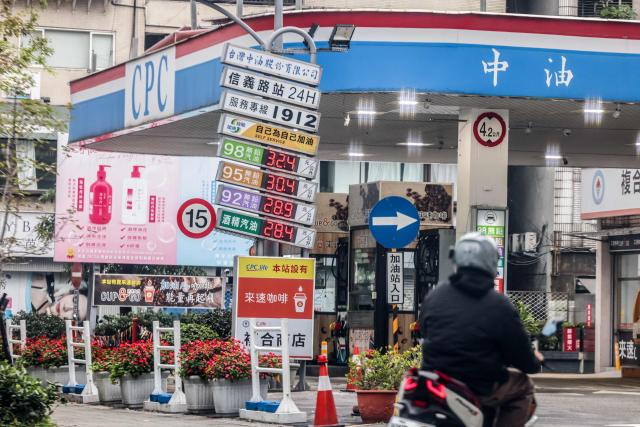 A motorcyclist rides into a gas station in Taipei on March 9, 2026. The price of the main US benchmark for oil surged more than 30 percent on March 9, 2026 over concerns that the Middle East war could create prolonged supply disruptions. (Photo by I-Hwa Cheng / AFP)