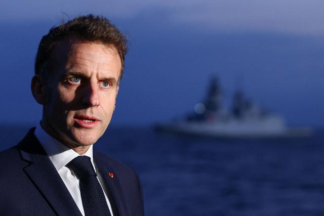 French President Emmanuel Macron addresses medias as he visits the French aircraft carrier Charles de Gaulle, deployed to the Mediterranean following Iranian drone strikes on Cyprus on the Mediterranean Sea, on March 9, 2026, on the sidelines of his trip to Cyprus to discuss regional security. (Photo by Gonzalo Fuentes / POOL / AFP)