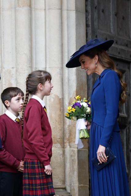 Britain's Catherine, Princess of Wales (R) receives a posy of flowers as shes departs after the annual Commonwealth Day service ceremony at Westminster Abbey in London, on March 9, 2026. (Photo by Brook Mitchell / AFP)