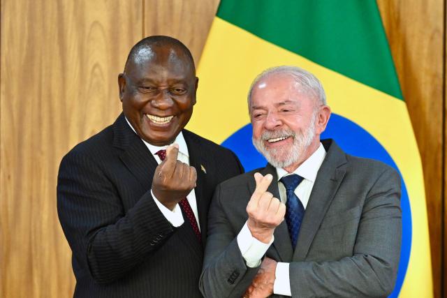 Brazil's President Luiz Inacio Lula da Silva (R) and South African President Cyril Ramaphosa gestures as they pose for a picture during a press statement at the Planalto Palace in Brasilia, on March 9, 2026. (Photo by Evaristo Sa / AFP)