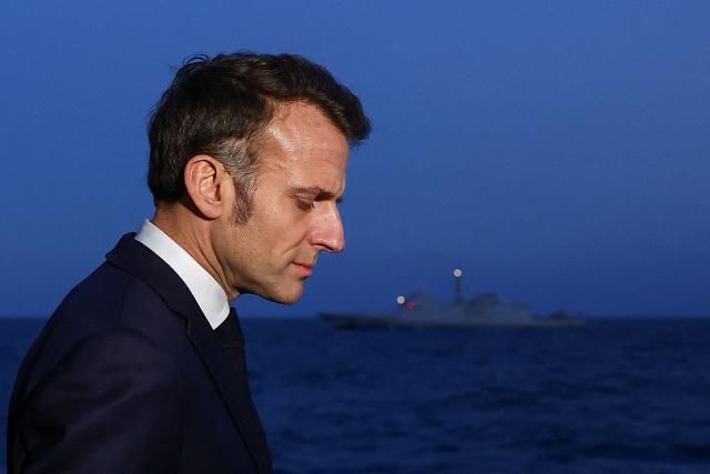 French President Emmanuel Macron arrives to address the media as he visits the French aircraft carrier Charles de Gaulle deployed in the Mediterranean Sea following Iranian drone strikes on Cyprus, on March 9, 2026, on the sidelines of his trip to Cyprus to discuss regional security. (Photo by Gonzalo Fuentes / POOL / AFP)