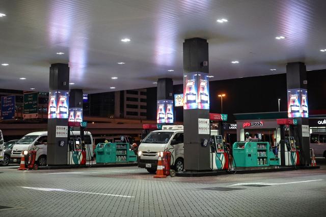 Drivers fill their vehicles with petrol at a gas station in Dubai on March 9, 2026. The Iran war sent oil prices spiralling above $100 a barrel on March 9, after Tehran under new leader supreme leader fired a new barrage of missiles at Israel and its crude-exporting Gulf neighbours. On the first day in power, the 56-year-old son of Iran's slain leader, renewed its missile and drone attacks on Saudi Arabia, Bahrein, Qatar, the UAE and Israel. (Photo by AFP) / Attention editors: AFP covers the war in the Middle East through its extensive regional network, including bureaus in Tehran, Jerusalem and several neighboring countries.Since the start of the conflict, journalists have been working under increasingly restrictive conditions. Authorities in several countries have limited reporters movements, photo and live video coverage from sensitive locations. Some governments and armed groups have banned images of missile or drone strikes and other security-related sites. / 
