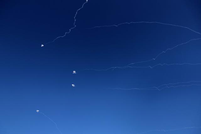 Rocket trails from an interception by Israel's Iron Dome missile defence system are pictured over Tel Aviv on March 9, 2026. Several blasts rocked central Israel on March 9, seriously injuring at least two people, emergency services said, shortly after the military reported it had detected new missiles launched from Iran. (Photo by JACK GUEZ / AFP) / Attention editors: AFP covers the war in the Middle East through its extensive regional network, including bureaus in Tehran, Jerusalem and several neighboring countries.Since the start of the conflict, journalists have been working under increasingly restrictive conditions. Authorities in several countries have limited reporters movements, photo and live video coverage from sensitive locations. Some governments and armed groups have banned images of missile or drone strikes and other security-related sites. / 