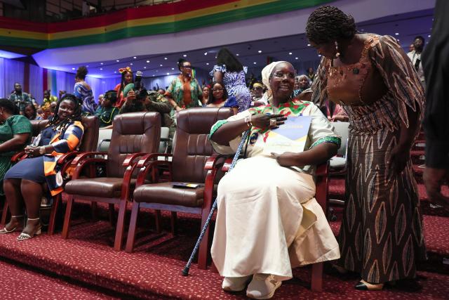 Ghana’s Vice President Naana Jane Opoku-Agyemang presents a certificate of registration to a member of the "historical diaspora" during the swearing-in ceremony where they took the oath of allegiance to become Ghanaian citizens in Accra, Ghana, on March 9, 2026. Ghana has sought to position itself as a prime destination for the African diaspora, which it describes as the country's "17th region", and has set up initiatives to attract descendants of enslaved Africans. (Photo by Nipah Dennis / AFP)