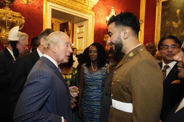 Britain's King Charles III speaks with guests during the annual Commonwealth Day Reception at St James's Palace in London on March 9, 2026. (Photo by Aaron Chown / POOL / AFP)