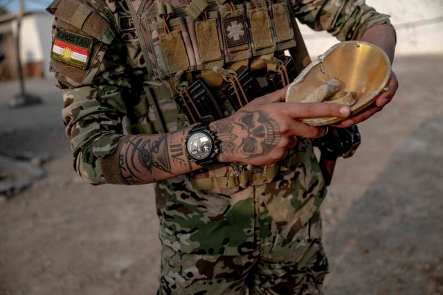 A Kurdish fighter, a member of The Organization of Iranian Kurdistan Struggle (Sazmani Khabat), shows pieces of an Iranian drone that had reportdly attacked their base near Erbil, in Iraq's northern autonomous Kurdish region on March 9, 2026. Iran has designated Kurdish rebels groups as terrorist organisations, and many have previously fought its security forces in Kurdish-majority areas along the border. (Photo by Ozan KOSE / AFP) / Attention editors: AFP covers the war in the Middle East through its extensive regional network, including bureaus in Tehran, Jerusalem and several neighboring countries.Since the start of the conflict, journalists have been working under increasingly restrictive conditions. Authorities in several countries have limited reporters movements, photo and live video coverage from sensitive locations. Some governments and armed groups have banned images of missile or drone strikes and other security-related sites. / 