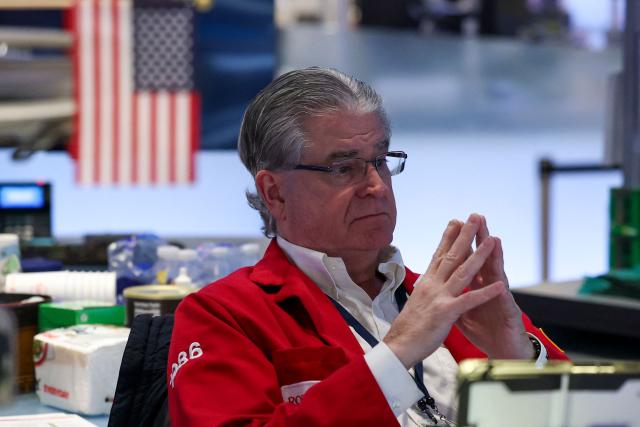 A trader works on the floor of the New York Stock Exchange (NYSE) during International Womens Day on March 9, 2026 in New York City. Wall Street stocks vaulted into positive territory after President Donald Trump described the US-Israeli war with Iran as "pretty much" over without giving details of any solution to the conflict still raging in the Middle East. All three major indices moved suddenly higher after the comments were reported, with the Dow Jones Industrial Average finishing 0.5 percent up at 47,740.80, a swing of 1,125 points from earlier in the day. (Photo by ANGELA WEISS / AFP)
