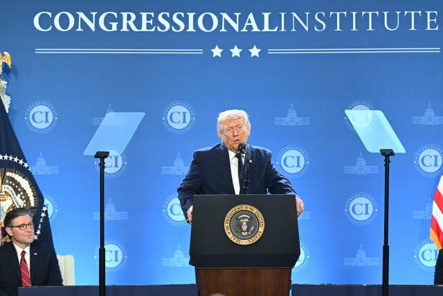 US President Donald Trump speaks as the Speaker of the House Mike Johnson (L) looks on during the Republican Members Issues Conference at Trump National Doral in Miami, Florida, on March 9, 2026. (Photo by SAUL LOEB / AFP)