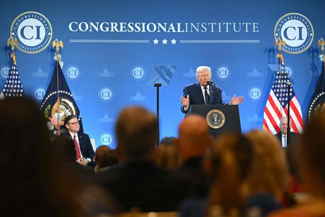 US President Donald Trump speaks as the Speaker of the House Mike Johnson (L) looks on during the Republican Members Issues Conference at Trump National Doral in Miami, Florida, on March 9, 2026. (Photo by SAUL LOEB / AFP)