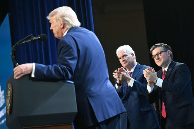 The Speaker of the House of Representatives Mike Johnson (R) and House Majority Whip Tom Emmer (C), Republican of Indiana, listen as US President Donald Trump speaks during the Republican Members Issues Conference at Trump National Doral in Miami, Florida, on March 9, 2026. (Photo by SAUL LOEB / AFP)