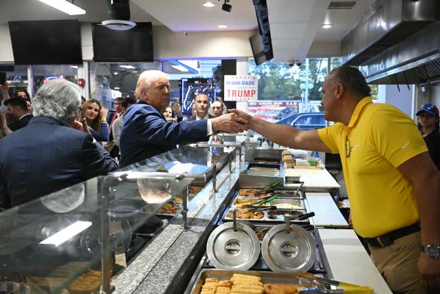 US President Donald Trump speaks with supporters at Venezuelan restaurant El Arepazo in Miami, Florida, March 9, 2026. (Photo by SAUL LOEB / AFP)