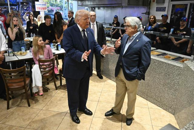 US President Donald Trump speaks with restaurant owner Max Alvarez at Venezuelan restaurant El Arepazo in Miami, Florida, March 9, 2026. (Photo by SAUL LOEB / AFP)