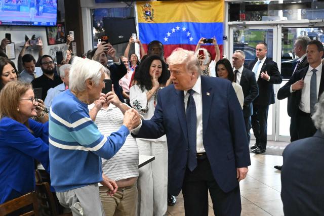 US President Donald Trump speaks with supporters at Venezuelan restaurant El Arepazo in Miami, Florida, March 9, 2026. (Photo by SAUL LOEB / AFP)