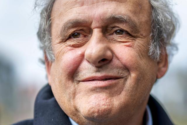 (FILES) Former UEFA president Michel Platini looks on when leaving the courthouse after the verdict of an appeal by Swiss Attorney General's office against former UEFA and FIFA presidents over a suspected fraudulent payment, in Muttenz near Basel, on March 25, 2025. Former UEFA president Michel Platini, who has filed a defamation suit against three former FIFA officials, said on March 9, 2026 that he was determined ‘not to let go of the people who have hurt [him]’. (Photo by Fabrice COFFRINI / AFP)