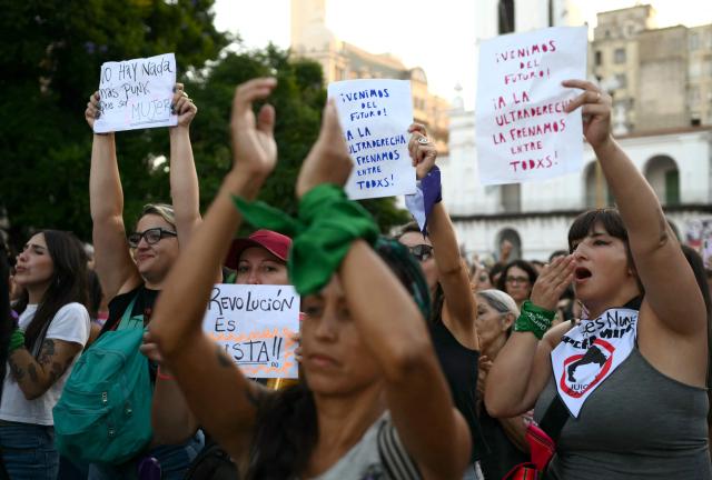 Women show signs during a march for the International Women's Day in Buenos Aires on March 9, 2026. The march was convened by feminist organizations to press historic demands against gender-based violence, to defend labor rights, and to oppose the economic austerity policies of Argentina’s President Javier Milei. (Photo by Luis ROBAYO / AFP)