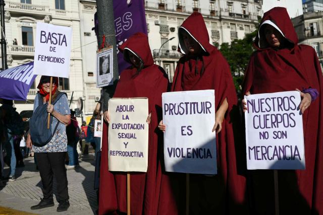 Demonstrators show signs during a march for the International Women's Day in Buenos Aires on March 9, 2026. The march was convened by feminist organizations to press historic demands against gender-based violence, to defend labor rights, and to oppose the economic austerity policies of Argentina’s President Javier Milei. (Photo by Luis ROBAYO / AFP)