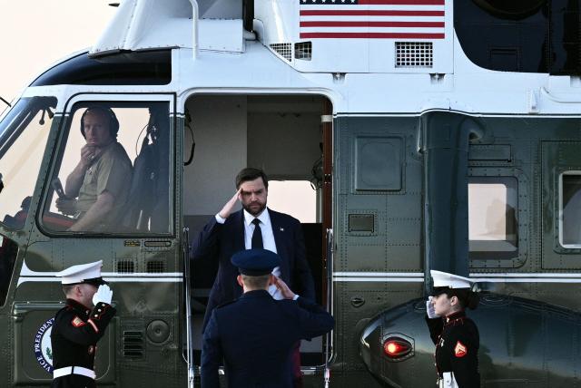 US Vice President JD Vance salutes as he exits Marine Two at Joint Base Andrews, Maryland,  to board Air Force One while on his way to Dover, Delaware to attend the dignified transfer solemn event for a US Army soldier on March 9, 2026. (Photo by Brendan SMIALOWSKI / AFP)