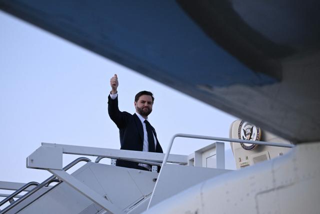 US Vice President JD Vance flashes a thumbs up as he boards Air Force Two at Joint Base Andrews, Maryland while on his way to Dover, Delaware to attend the dignified transfer solemn event for a US Army soldier on March 9, 2026. (Photo by Brendan SMIALOWSKI / AFP)