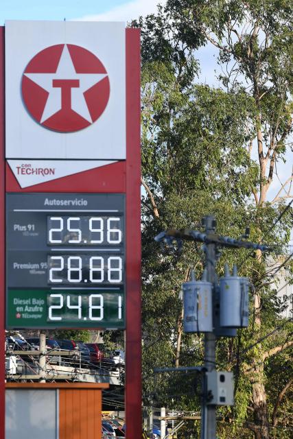 The new fuel prices are seen on a fuel price board at a gas station in Tegucigalpa on March 9, 2026. The prices of petroleum derivatives soared on March 9 in Honduras due to the war in the Middle East. (Photo by Orlando SIERRA / AFP)