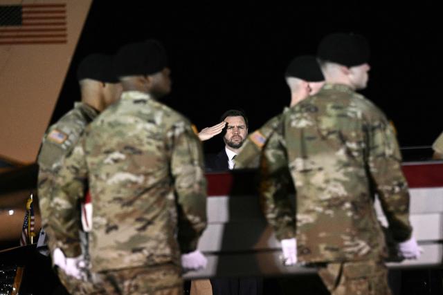 US Vice President JD Vance salutes as members of a US Army team carry a flagged-drapped transfer case containing the remains of Sgt. Benjamin N. Pennington, 26, of Glendale, Kentucky, during a dignified transfer solemn event at Dover Air Force Base, in Dover, Delaware, on March 9, 2026. (Photo by Brendan SMIALOWSKI / AFP)