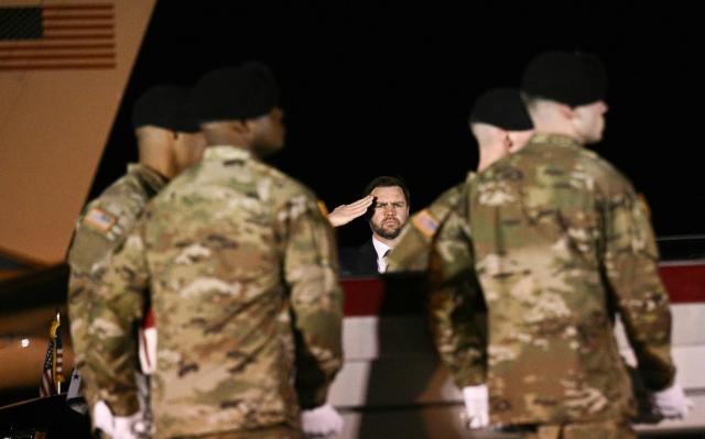 US Vice President JD Vance salutes as members of a US Army team carry a flagged-drapped transfer case containing the remains of Sgt. Benjamin N. Pennington, 26, of Glendale, Kentucky, during a dignified transfer solemn event at Dover Air Force Base, in Dover, Delaware, on March 9, 2026. (Photo by Brendan SMIALOWSKI / AFP)
