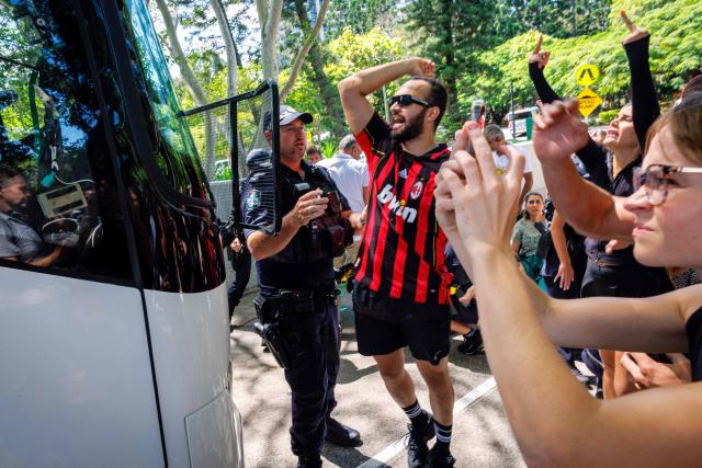 Members of the Iranian community in Australia block the path of a departing bus transporting members of the Iranian Women’s Asia Cup football team to the airport, outside the Royal Pines Resort on the Gold Coast on March 10, 2026. Five players from Iran's visting women's football team claimed asylum in Australia on March 10, seeking protection after they were branded "traitors" at home for refusing to sing the national anthem. (Photo by Patrick HAMILTON / AFP)