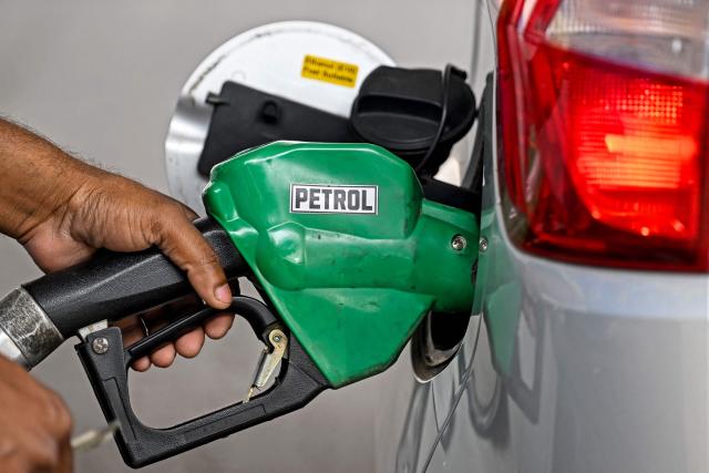 A petrol pump attendant refuels a vehicle at a Bharat Petroleum (BP) gas station in New Delhi on March 10, 2026. Oil prices tanked and equities rallied on March 10, following a wild day of swings that came after Donald Trump said the US-Israel war on Iran would be ending earlier than thought. (Photo by Sajjad HUSSAIN / AFP)
