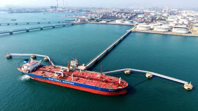 An oil tanker unloads crude oil at a terminal at the port in Qingdao, in China’s eastern Shandong province on March 10, 2026. (Photo by CN-STR / AFP) / China OUT