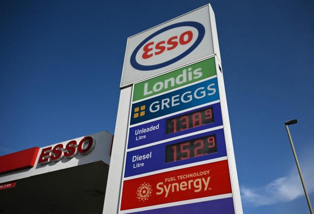 The price per litre of unleaded petrol and diesel fuels are pictured outside an Esso petrol station in Lutterworth, near Rugby in central England, on March 10, 2026. Oil and gas prices tumbled after US President Donald Trump said "I think the war is very complete, pretty much". World oil prices dropped by around eight percent, while the European benchmark gas price, the Dutch TTF natural gas contract, fell around 15 percent. (Photo by Oli SCARFF / AFP)