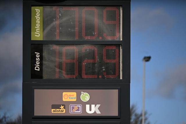 The price of unleaded and diesel fuels are pictured on a digital display board at the petrol station of a motorway services near Leicester in central England, on March 10, 2026. Oil and gas prices tumbled after US President Donald Trump said "I think the war is very complete, pretty much". World oil prices dropped by around eight percent, while the European benchmark gas price, the Dutch TTF natural gas contract, fell around 15 percent. (Photo by Oli SCARFF / AFP)