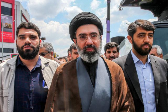 (FILES) In this picture obtained from Iran's ISNA news agency, Mojtaba Khamenei (C), son of Iran's supreme leader Ayatollah Ali Khamenei, walks along a street in Tehran on May 31, 2019. Iran marked the appointment of Ayatollah Mojtaba Khamenei to replace his father as its supreme leader with a new barrage of missiles against Israel and the Gulf states on March 9, 2026, as the Middle East war sent oil prices soaring. (Photo by Hamid FOROUTAN / ISNA / AFP)