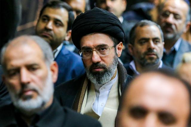 (FILES) In this picture obtained from Iran's ISNA news agency, Mojtaba Khamenei (C), son of Iran's supreme leader Ayatollah Ali Khamenei, looks on during a gathering in Tehran on July 18, 2016. Iran marked the appointment of Ayatollah Mojtaba Khamenei to replace his father as its supreme leader with a new barrage of missiles against Israel and the Gulf states on March 9, 2026, as the Middle East war sent oil prices soaring. (Photo by AMIR KHOLOUSI / ISNA / AFP)