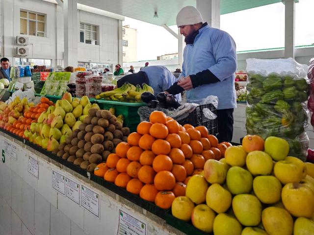 A vendor sells fruits grown and imported from Iran at a market in the Turkmen capital of Ashgabat on March 9, 2026. (Photo by AFP)