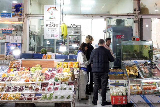 People shop for produce from a bazaar in Tehran on March 10, 2026. Iran marked the appointment of Ayatollah Mojtaba Khamenei to replace his father as its supreme leader with a new barrage of missiles against Israel and the Gulf states on March 9, as the Middle East war sent oil prices soaring. (Photo by AFP) / Attention editors: AFP covers the war in the Middle East through its extensive regional network, including bureaus in Tehran, Jerusalem, and several neighboring countries. Since the start of the conflict, journalists have been working under increasingly restrictive conditions. Authorities in several countries have limited reporters' movements, photo and live video coverage from sensitive locations. Some governments and armed groups have banned images of missile or drone strikes and other security-related sites. / 