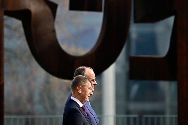 German Chancellor Friedrich Merz and Czech Republic's Prime Minister Andrej Babis listen to the national anthems during a welcoming ceremony at the Chancellery in Berlin, Germany, on March 10, 2026. (Photo by Tobias SCHWARZ / AFP)