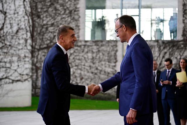 German Chancellor Friedrich Merz (R) and Czech Republic's Prime Minister Andrej Babis shake hands at the Chancellery in Berlin, Germany, on March 10, 2026. (Photo by Tobias SCHWARZ / AFP)